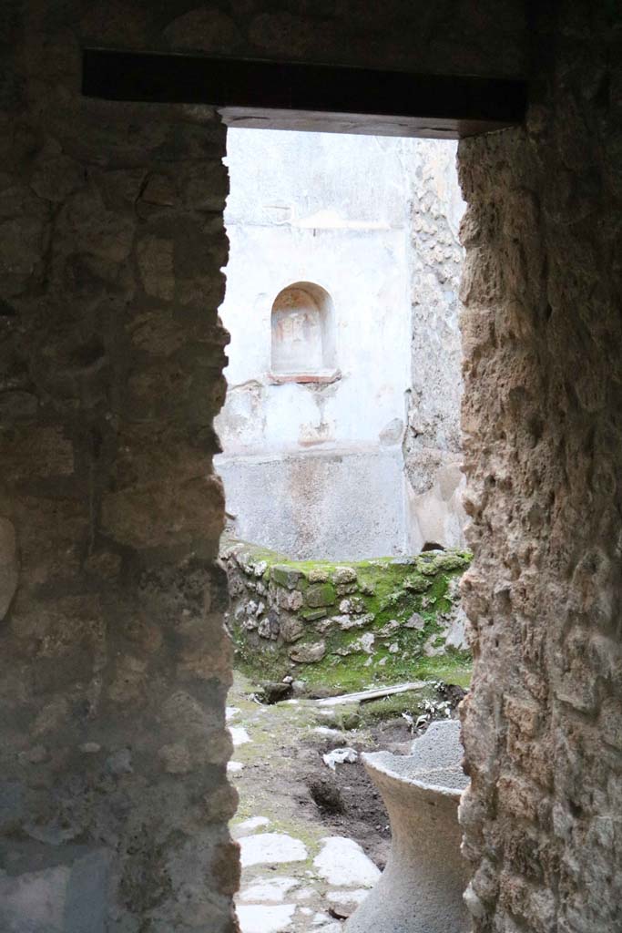 VII.1.47, Pompeii. December 2018. 
Room 17, looking through doorway leading west towards room 12, and lararium in VII.1.46.
Photo courtesy of Aude Durand.