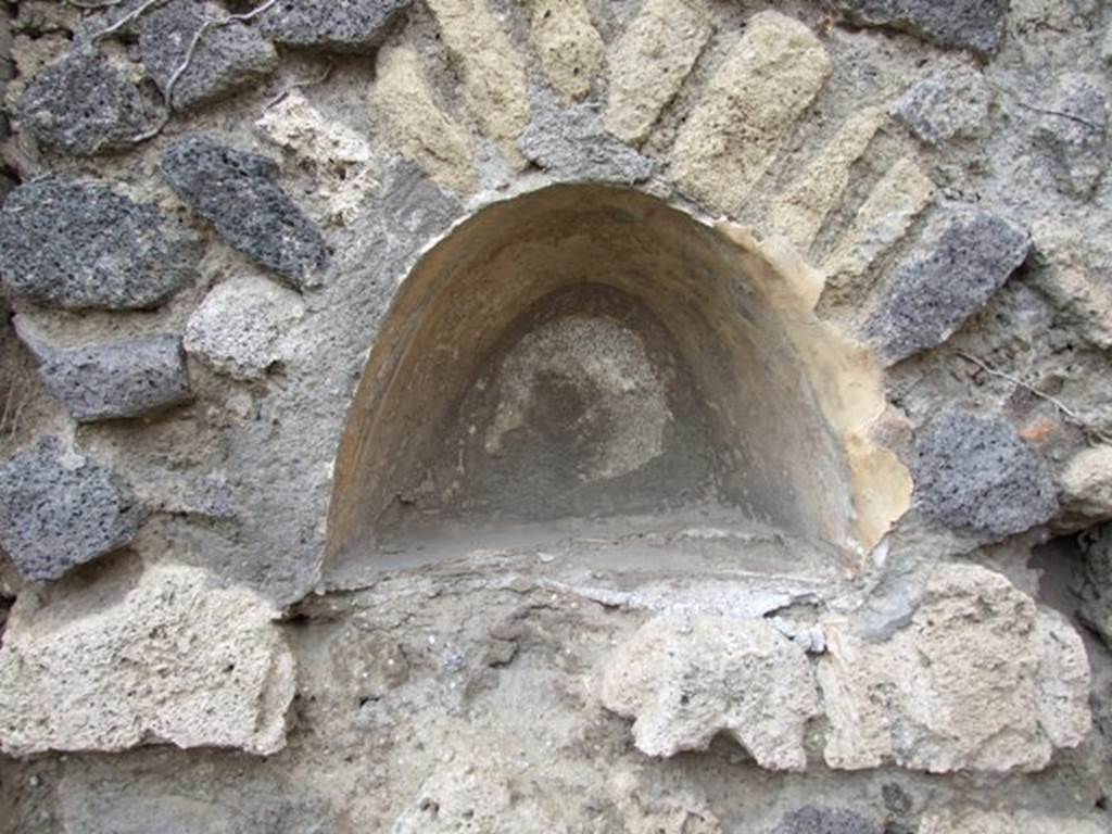 VII.2.12 Pompeii. December 2007. Niche in west wall. According to Boyce, this arched niche had walls coated with white stucco and decorated with broad red bands. Fiorelli called it la nicchia de’ Penati.
See Boyce G. K., 1937. Corpus of the Lararia of Pompeii. Rome: MAAR 14. (p.61, 248) 
See Pappalardo, U., 2001. La Descrizione di Pompei per Giuseppe Fiorelli (1875). Napoli: Massa Editore. (p.81)