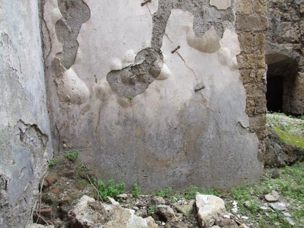 VII.2.14 Pompeii. March 2009. 
North wall of garden room with remains of lararium painting with serpent.  A painting of two gods and two Lares was above this.
See Fröhlich, T., 1991. Lararien und Fassadenbilder in den Vesuvstädten. Mainz: von Zabern. (p283: L80: T40,1.3).
According to Boyce, in the north wall on the east side of this lararium painting, was a window set in a recess which overlooked the kitchen.
On the west wall of this recess, around the corner, was painted a man. (see below).