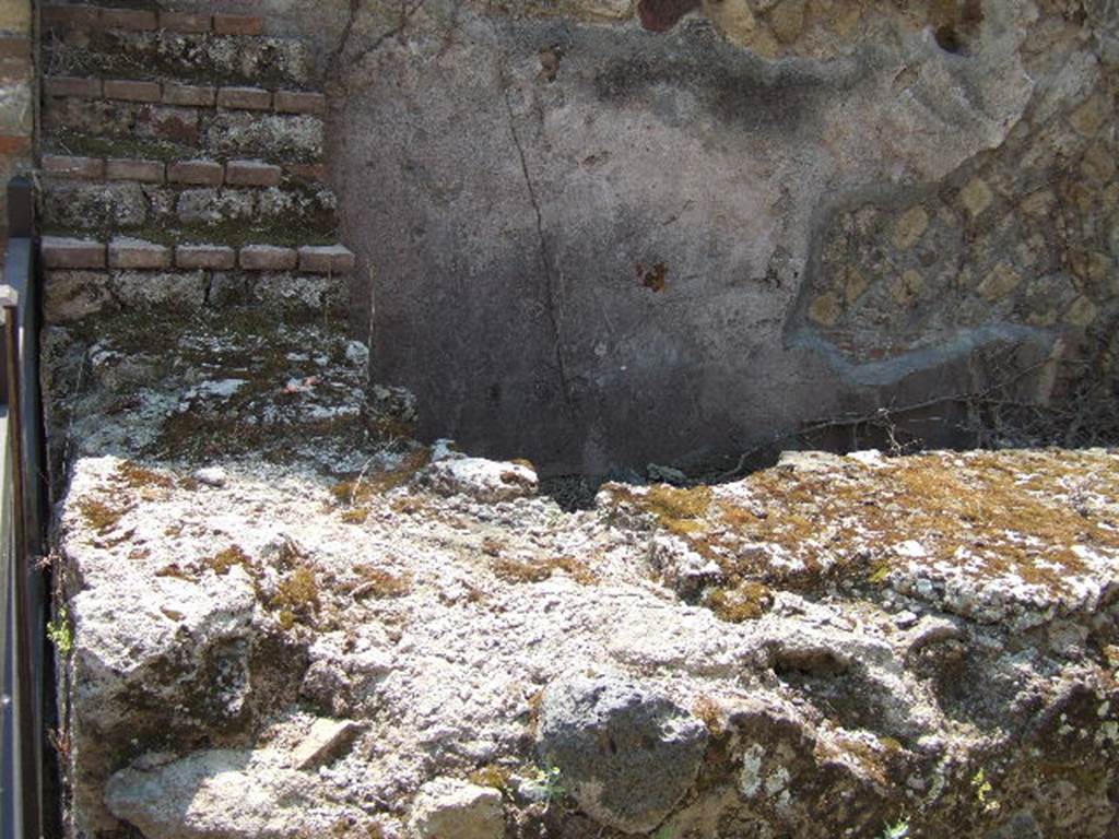VII.2.15 Pompeii. May 2006. Counter, with display shelving against the south wall.