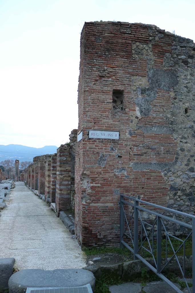 VII.2.15 Pompeii. December 2018. 
Looking south on Via Stabiana, on left, towards corner wall of VII.2.15, at junction with Vicolo del Panetierre, on right. 
Photo courtesy of Aude Durand.