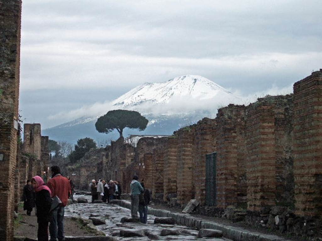 Pompeii. December 2005. Looking north on Via Stabiana to a snow covered Vesuvius, from VII.2.15.