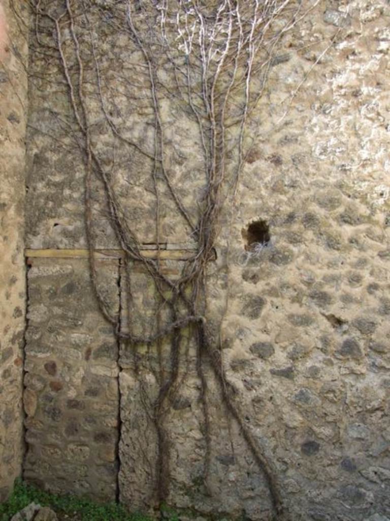 VII.2.18 Pompeii. March 2009. Room 9, west wall of cubiculum or porter’s room.   This includes a blocked door, that used to lead to a small room under the staircase of VII.2.19.