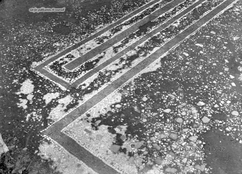 VII.2.20 Pompeii. c.1930. Room 3, flooring
DAIR 41.642. Photo © Deutsches Archäologisches Institut, Abteilung Rom, Arkiv.
See Pernice, E.  1938. Pavimente und Figürliche Mosaiken: Die Hellenistische Kunst in Pompeji, Band VI. Berlin: de Gruyter, (described as cubiculum “e” ,see tav. 20.4, above.)
According to PPM, 
The flooring of the interior of the room, although in its simplicity, emphasized the destination of the parts of the room with the drop in the alcove and the carpet pattern in the antechamber. Inserted in the beaten flooring, were irregular small limestone flakes, a set of black tesserae consisting of a band of seven rows within a rectangle of four, and the edge of the carpet of the antechamber formed by bands of six rows of the same black tiles.
See Carratelli, G. P., 1990-2003. Pompei: Pitture e Mosaici. 6. VI. Roma: Istituto della enciclopedia italiana, (p. 624).