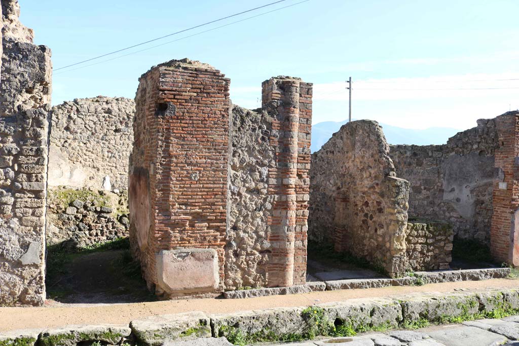 VII.2.24, Pompeii, on left, with VII.2.25, centre, and VII.2.26, on right. December 2018. 
Looking east in Vicolo Storto. Photo courtesy of Aude Durand.