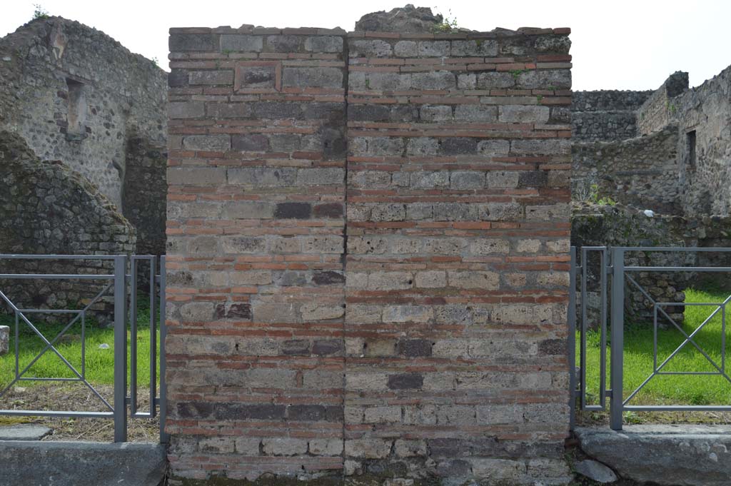 VII.3.23 Pompeii, on left. March 2018. Looking west towards pilaster on north side of entrance doorway showing plaque with phallus.
Foto Taylor Lauritsen, ERC Grant 681269 DÉCOR.