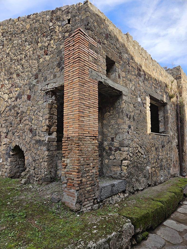 VII.3.28 Pompeii, on left. November 2024. 
Looking east from VII.3.28 along front façade, with doorway to steps at VII.3.27, and window at VII.3.26.
Photo courtesy of Annette Haug.