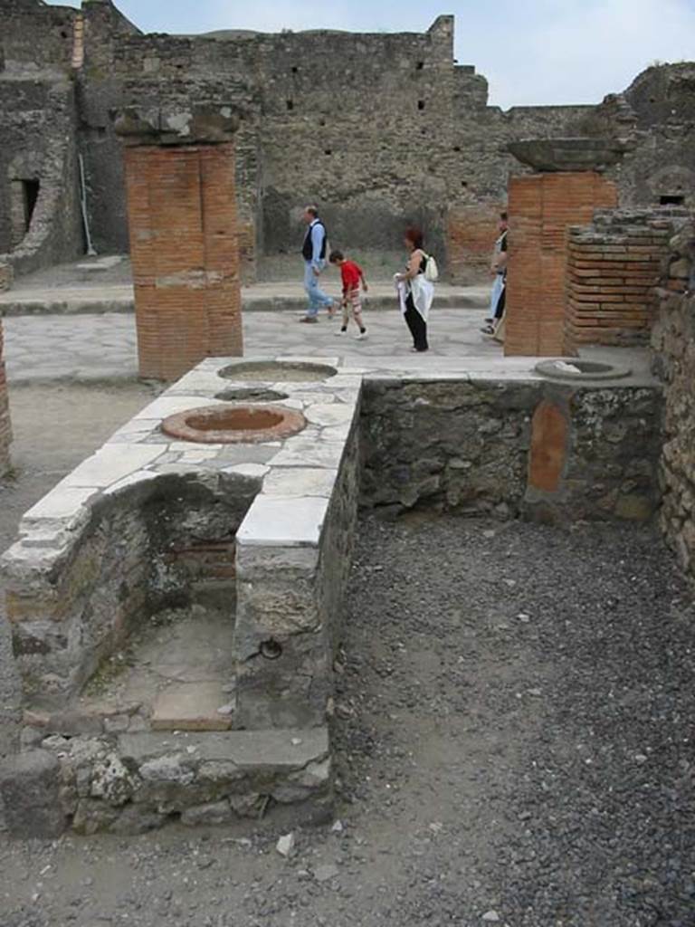VII.4.4 Pompeii. May 2003.  Looking west towards Via del Foro, from rear of counter with hearth on its eastern end. Photo courtesy of Nicolas Monteix.