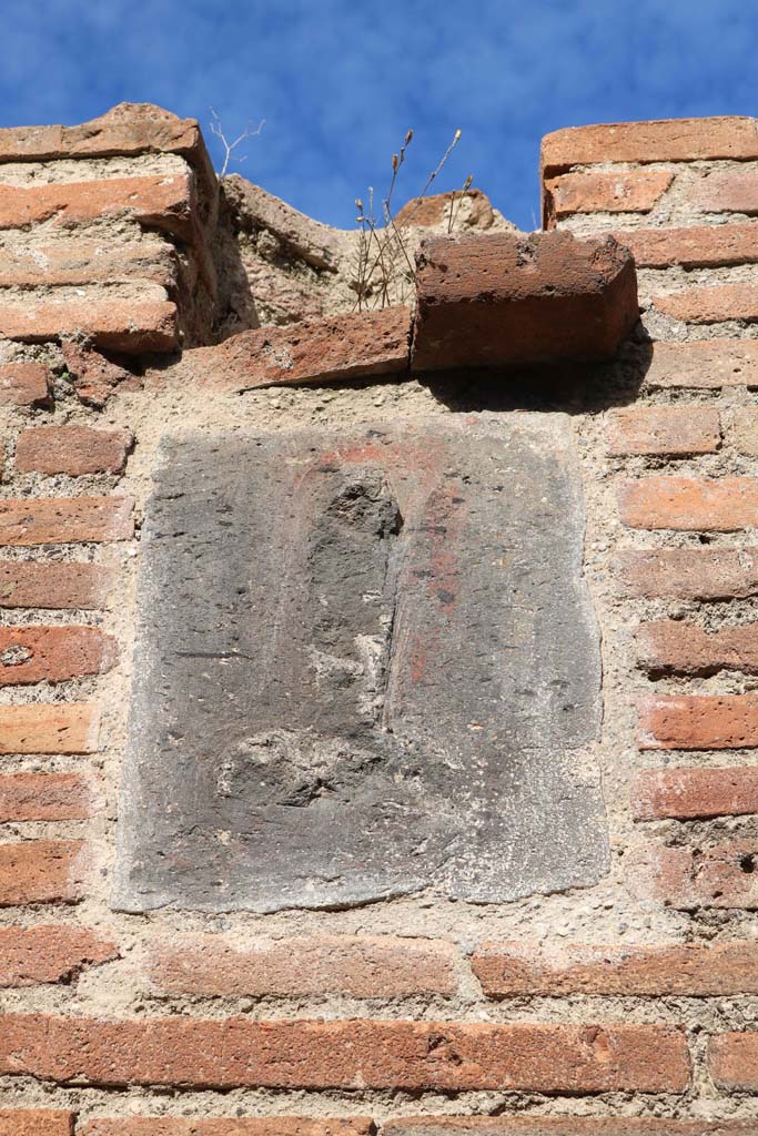 VII.4.27 Pompeii. December 2018. 
Plaque on pillar on west (left) side of entrance. Photo courtesy of Aude Durand.