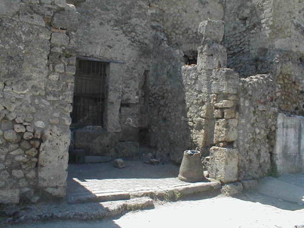VII.4.63 Pompeii. May 2005.  Entrance, with downpipe from upper floor latrine in rear south-west corner, on right. On the right, in front of the downpipe, would have been the stairs to the upper floor. In the south wall was a window looking into VII.4.62.
See Eschebach, L., 1993. Gebäudeverzeichnis und Stadtplan der antiken Stadt Pompeji. Köln: Böhlau. (p.285)