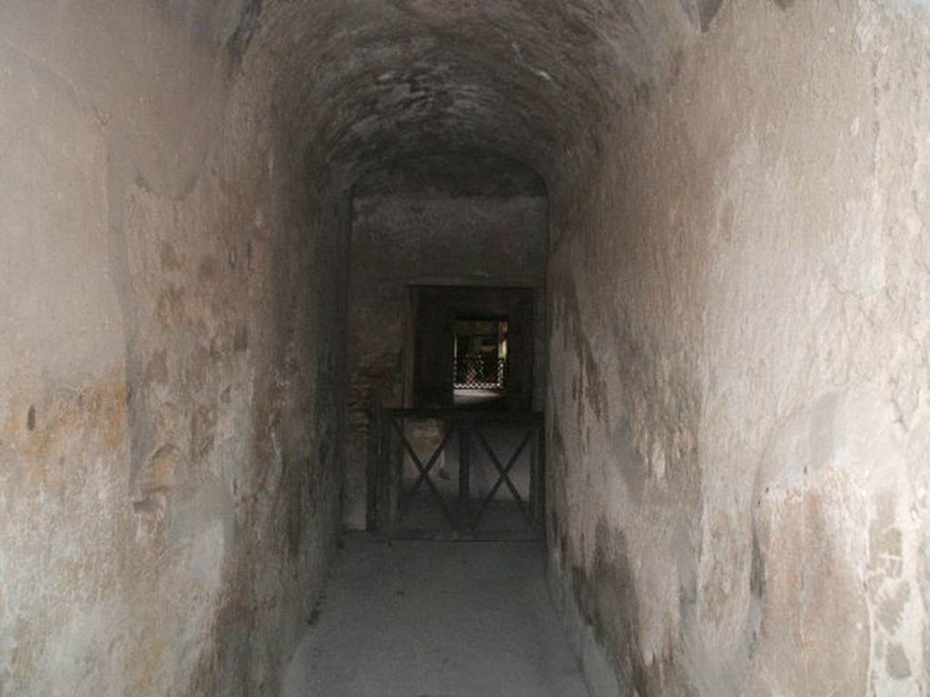 VII.5.2 Pompeii. May 2005. Looking south along corridor (16) into men’s baths and changing room (14).
According to Fiorelli –
This corridor would have led directly into the changing room (apodyterium), consisting of a large room with seating on three sides (14).
