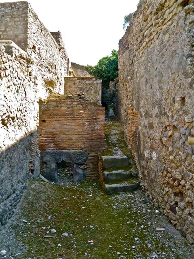 VII.5.7 Pompeii. May 2011. Looking south from entrance (26)  across the furnace room (25). Remains of praefurnium front (27) between the men’s and women’s baths. Photo courtesy of Michael Binns.