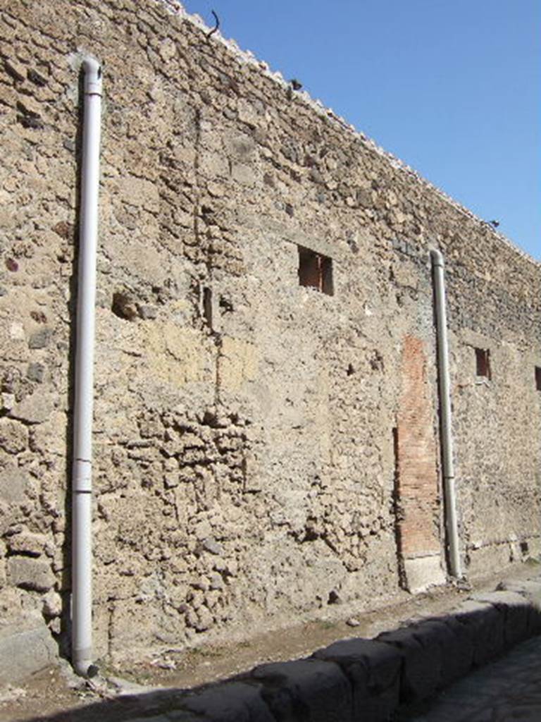 VII.5.17 Pompeii. September 2005. Looking north-east towards site of entrance doorway. According to Garcia y Garcia, all of the south-west corner and southern part of the insula were transformed in the time of Maiuri. Then the area was hit during the first bombing incursion during the early evening (17.00hrs) of 13th September 1943. All of the old structures that remained have been modified again to provide a restaurant, toilets and sales area. The modifications included closing and bricking up of the old doorways to VII.5.14, 15, 16 and 17. Entrances at VII.5.18, 19 and 20 now provide the doorways to the modern restaurant. 
See Garcia y Garcia, L., 2006. Danni di guerra a Pompei. Rome: L’Erma di Bretschneider. (p.101-3).