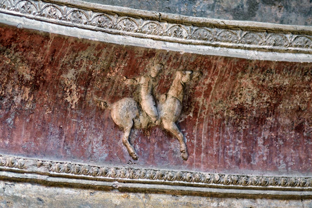 VII.5.24 Pompeii. April 2018. Frigidarium. Detail of cupid on horse-back from stucco cornice.  
Photo courtesy of Ian Lycett-King. Use is subject to Creative Commons Attribution-NonCommercial License v.4 International.