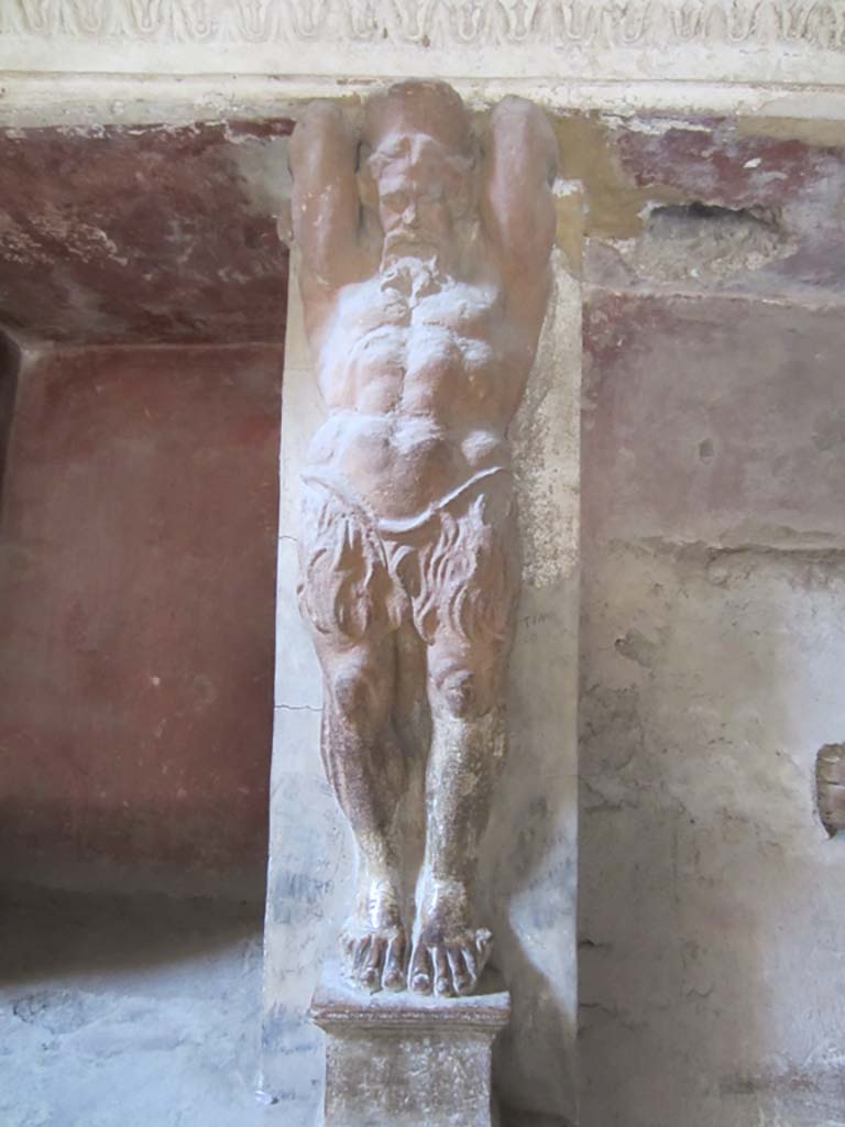 VII.5.24 Pompeii. March 2012. 
Tepidarium (37), detail of a telamon from west wall on south side of doorway. Photo courtesy of Marina Fuxa.