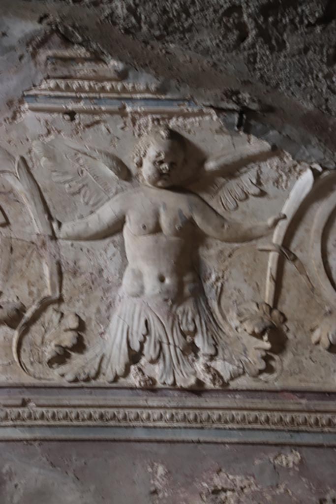 VII.5.24 Pompeii. May 2024. 
Plaster stucco on west wall of tepidarium (37), above doorway to caldarium. Photo courtesy of Klaus Heese.