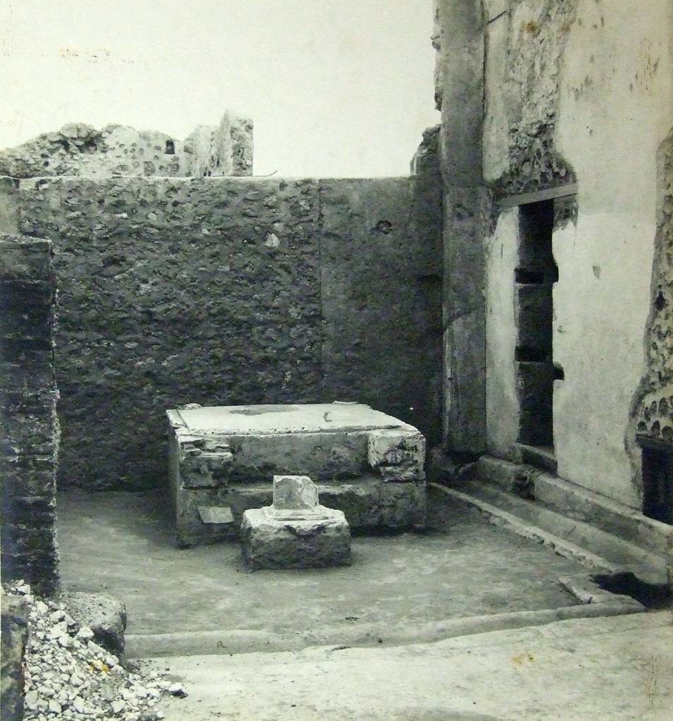 VII.6.3 Pompeii. 1910. Room 18, viridarium in south-west corner of the peristyle. 
Base of a Temple Lararium shrine (r) with a small altar in front.
According to Jashemski, 
“Professor Richardson has shown that the well-known archaic statue of Diana, (Mus. Naz. Inv. No. 6008) which was found at Pompeii in 1760, came from the large and elegant shrine in the south-west part of the garden. There was a tufa altar in front of the shrine”.
See Jashemski, W. F., 1993. The Gardens of Pompeii, Volume II: Appendices. New York: Caratzas. (p.184).
Photograph courtesy of Soprintendenza Speciale per i Beni Archeologici di Napoli e Pompei.