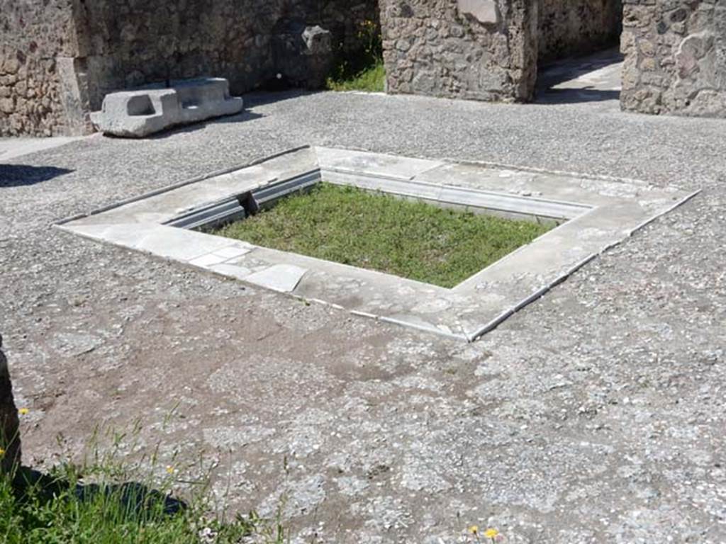 VII.7.5 Pompeii, May 2018. 
Looking south-west across atrium towards large piece of travertine for the strong-box, and doorways to rooms (c) and (d) on west side of atrium. 
Photo courtesy of Buzz Ferebee.