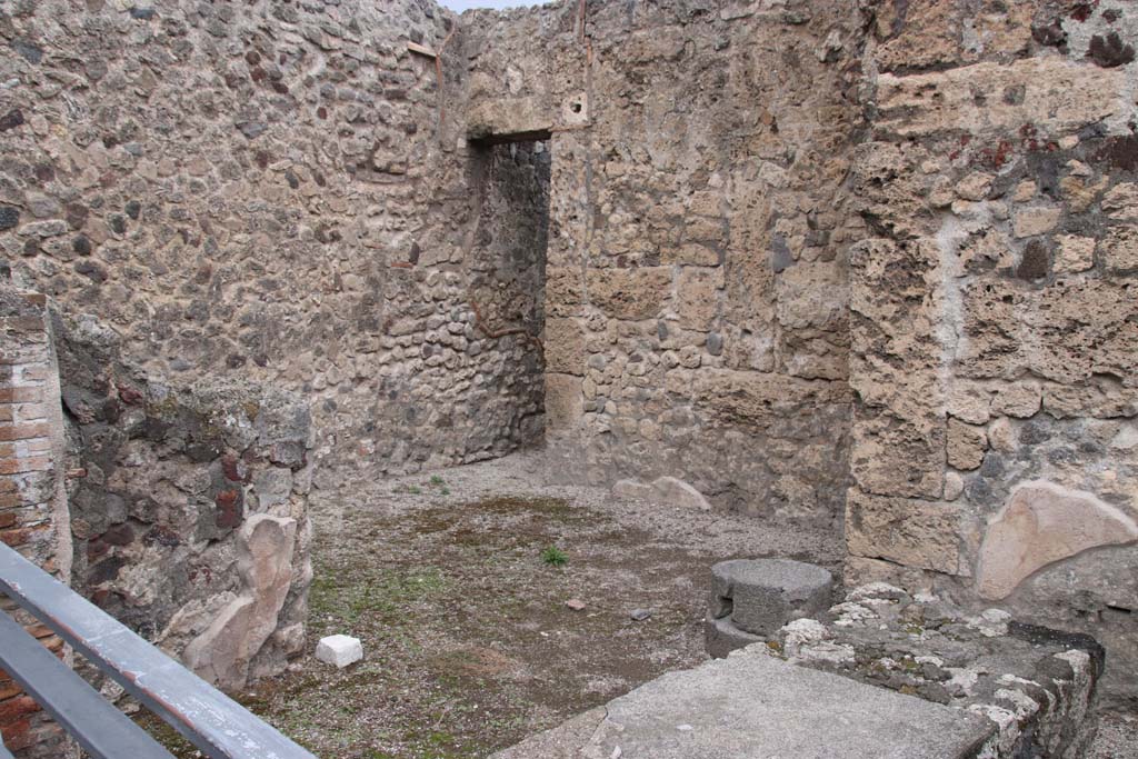 VII.7.11 Pompeii. October 2020. Looking north-west across counter in shop, from entrance doorway. 
The doorway in the north wall, leading to latrine, is behind the area of the steps at VII.7.12. Photo courtesy of Klaus Heese.