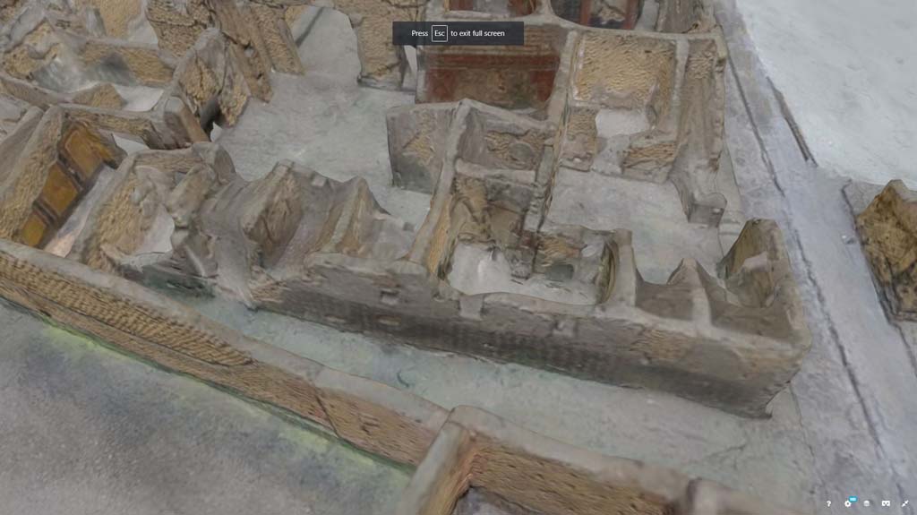 VII.7.21, Pompeii. October 2017. Detail from model in Naples Archaeological Museum.
Looking west in small alley/vicolo towards side wall of VII.7.21, leading to doorway of VII.7.23, centre left. 
The Zebra Stripe decoration can be seen along the wall. 
Information and Foto from Taylor Lauritsen, ERC Grant 681269 DÉCOR.