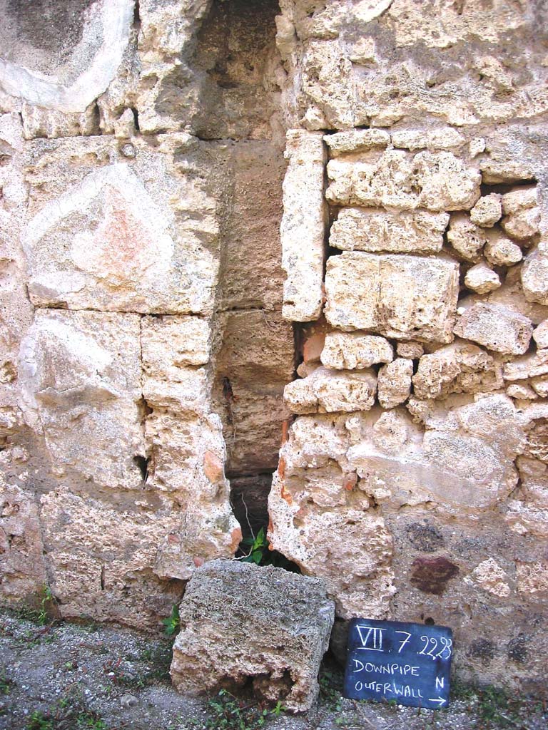 VII.7.23 Pompeii. July 2008. 
Looking towards outer west wall of small alley, with downpipe. Photo courtesy of Barry Hobson.