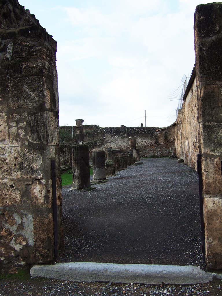 VII.7.32 Pompeii. December 2005. Entrance doorway to Temple of Apollo on west side of Forum.
According to Gell –
“Entrance to the enclosure of a temple. It may also be approached from the Forum by other openings. No name has hitherto, with sufficient authority, been applied to this edifice. On the spot, a portion of a female statue, found therein, has induced the excavators to assign it to Venus; while the pictures found within its enclosure do not afford much better ground for supposing it of any other divinity. Around the walls of the porticoes, at 2 feet 6 inches from the ground, runs a series of paintings, of dwarfs and architectural subjects. In one corner is a painting of Achilles and Agamemnon: in another Hector tied to the chariot of Achilles: and in an apartment is a picture of Bacchus and Silenus.”
See Gell, W, and Gandy J. P., 1821. Pompeiana: 2nd edition. London: Rodwell and Martin, (p.216-217).