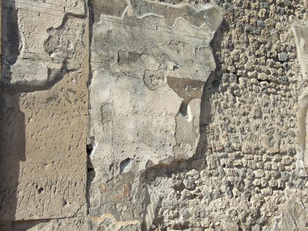 VII.7.32 Pompeii. March 2009. Remains of plaster on east wall at side of entrance doorway.