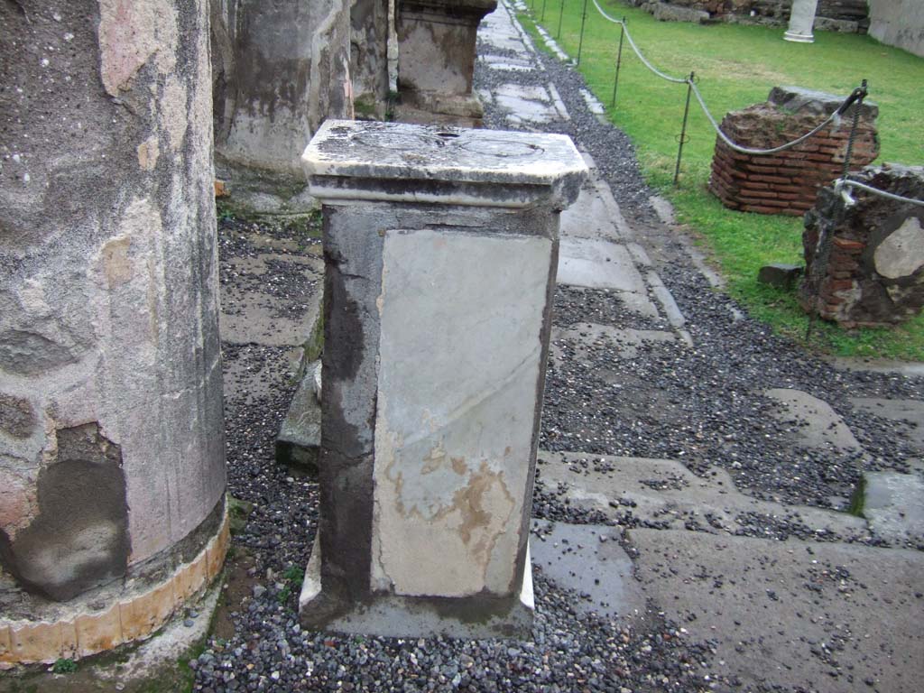 VII.7.32 Pompeii. December 2005. West side. Pedestal that used to hold a statue. 
There were three statues on either side, grouped in pairs.
All original statues are now in the Naples Archaeological Museum.
See Mau, A., 1907, translated by Kelsey F. W. Pompeii: Its Life and Art. New York: Macmillan. (p.87)