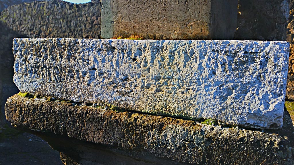 VII.7.32 Pompeii. December 2019. 
Looking south-west to inscribed stone at base of statue of Artemis. Photo courtesy of Giuseppe Ciaramella.
