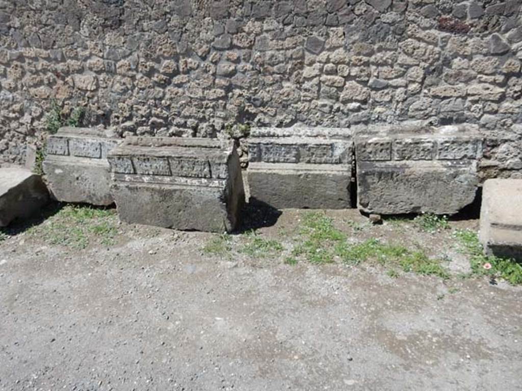 VII.7.32 Pompeii. May 2018. Remains of stones with decoration from the Temple, against the west wall. 
Photo courtesy of Buzz Ferebee.