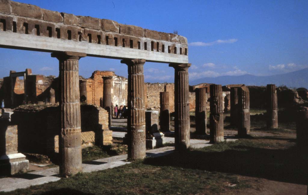 VII.8 Pompeii Forum. February 1988. 
Looking north-east from south side, towards Via dell’Abbondanza and south side of Eumachia’s Building.
Photo by Joachime Méric courtesy of Jean-Jacques Méric.
