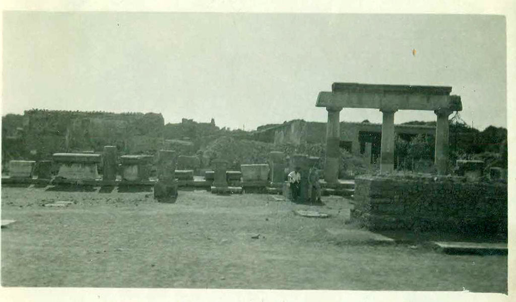 VII.8 Pompeii Forum. September 1944. Looking west across forum. Photo courtesy of Rick Bauer.
In the centre rear of the photo there appears to be a pile of rubble, presumably debris from the 1943 bombing. 
According to Garcia y Garcia, in this area, which had been reconstructed by Mauri, all the antiquities from pre-Samnite Pompeii were kept.
This area was completely destroyed by bombing in 1943 together with the rooms on its south side, part of the Temple of Apollo, known as “la sagrestia”.
However, the major loss was the destruction of the collection from the archaic period.
The area has now been restored and altered with modern modifications, and once again used as a store for archaeological materials.
See Garcia y Garcia, L., 2006. Danni di guerra a Pompei. Rome: L’Erma di Bretschneider, (p.117).