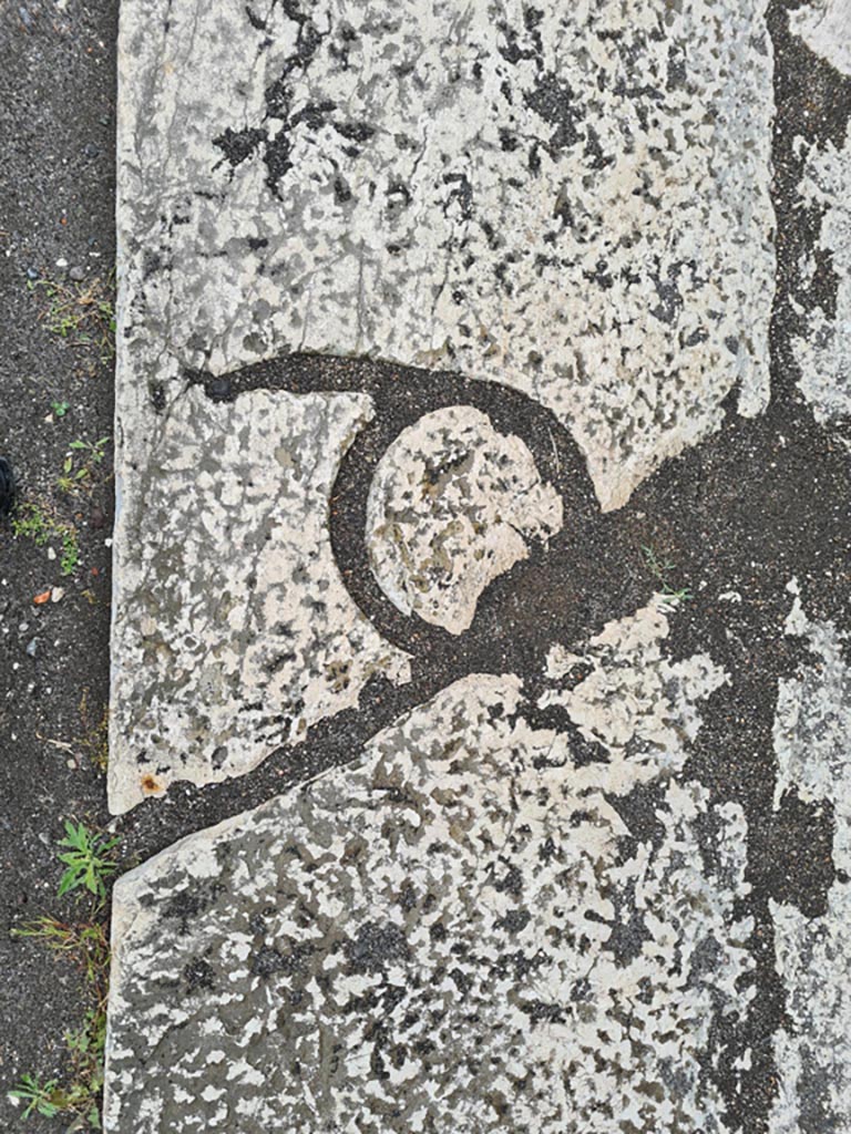 VII.8 Pompeii Forum. May 2024. 
Letter Q, in a block of the pavement immediately to the east of the very large base which is situated at about the middle of the west side of the Forum. Photo courtesy of Klaus Heese.