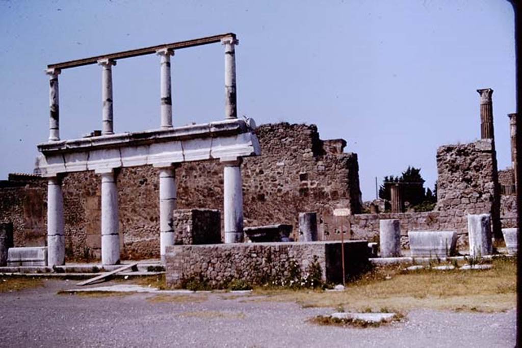 VII.8 Pompeii Forum. 1964. Looking west across Forum towards one of the side entrances to the Temple of Apollo, now partly filled in/closed.  Photo by Stanley A. Jashemski.
Source: The Wilhelmina and Stanley A. Jashemski archive in the University of Maryland Library, Special Collections (See collection page) and made available under the Creative Commons Attribution-Non Commercial License v.4. See Licence and use details.
J64f2013