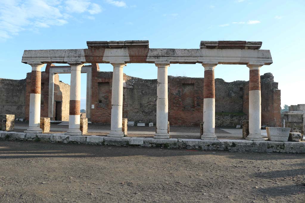 VII.9.1 Pompeii. December 2018. 
Looking east across Forum towards Eumachia’s portico, and entrance doorway. Photo courtesy of Aude Durand.
