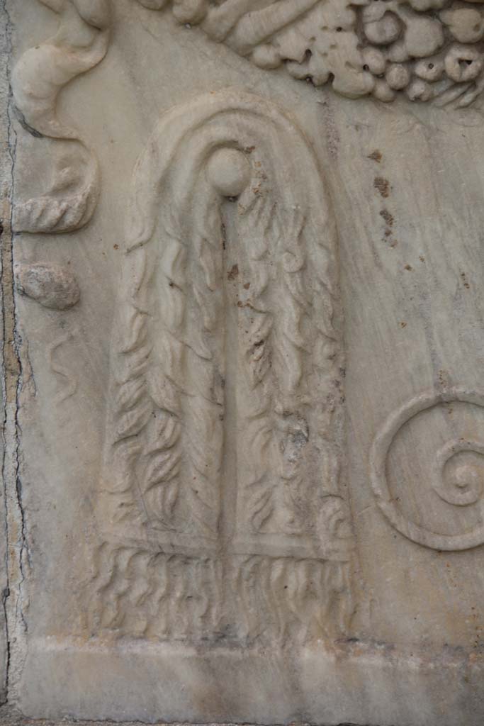 VII.9.2 Pompeii. April 2014. Detail of mantle on south side of Altar.
Photo courtesy of Klaus Heese.