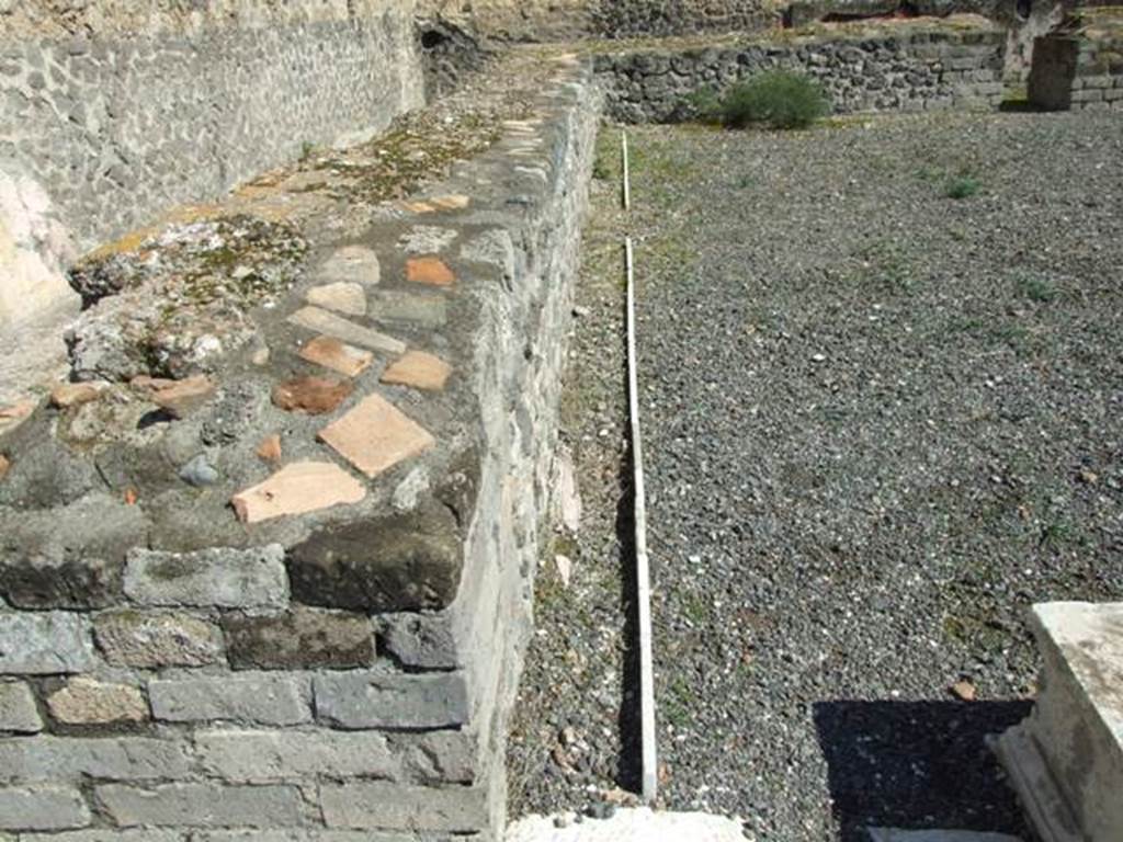 VII.9.7 and VII.9.8 Pompeii. Macellum. March 2009. Large room in south-east corner.  
Looking east along the front of counter at north end.  A water channel ran round the counter conveying running water.