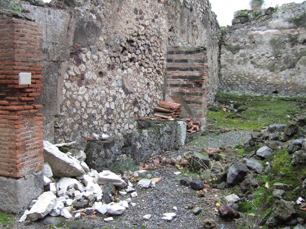 VII.9.44 Pompeii. December 2005. Looking south-east across entrance doorway.  According to Eschebach on the left would have been the remains of the base two steps of the stairs to the upper floor. See Eschebach, L., 1993. Gebäudeverzeichnis und Stadtplan der antiken Stadt Pompeji. Köln: Böhlau. (p.316)