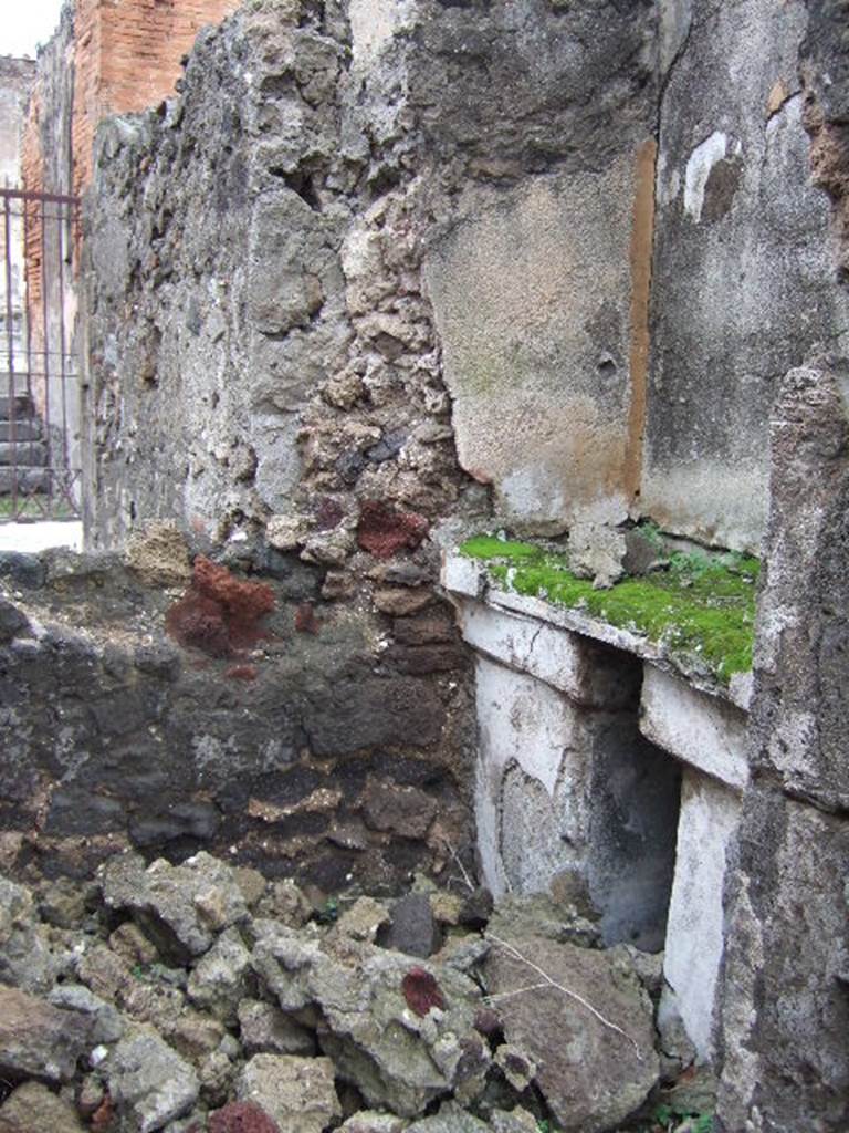 VII.9.47 Pompeii. December 2005. Room 10, sacellum.
According to PPM, a masonry altar was built in a recess against the east wall supported by two massive pillars which were painted in black: 
the middle zone of the wall painted above, was in yellow.
See Pompei: Pitture e Mosaici, Vol. VII  parte 1, Roma: Istituto della enciclopedia italiana, (p.364)