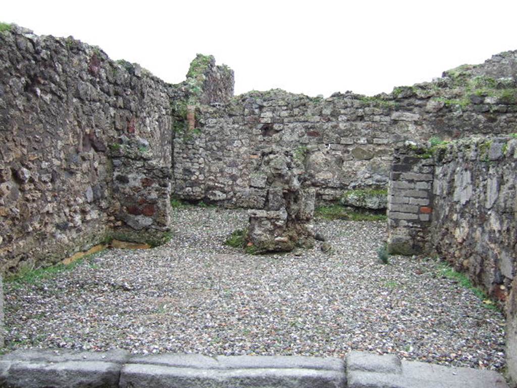 VII.9.50 Pompeii.  December 2005. Looking south across shop, to two rear rooms. According to Fiorelli, the shop had a counter with a simple hearth and at the rear were two rooms, one with the usual staircase.  See Pappalardo, U., 2001. La Descrizione di Pompei per Giuseppe Fiorelli (1875). Napoli: Massa Editore.(p107)  According to Liselotte Eschebach, to the left was a rear room with a hearth, and a downpipe from latrine on upper floor. To the right was another room with a staircase to the upper floor.  See Eschebach, L., 1993. Gebäudeverzeichnis und Stadtplan der antiken Stadt Pompeji. Köln: Böhlau. (p317)