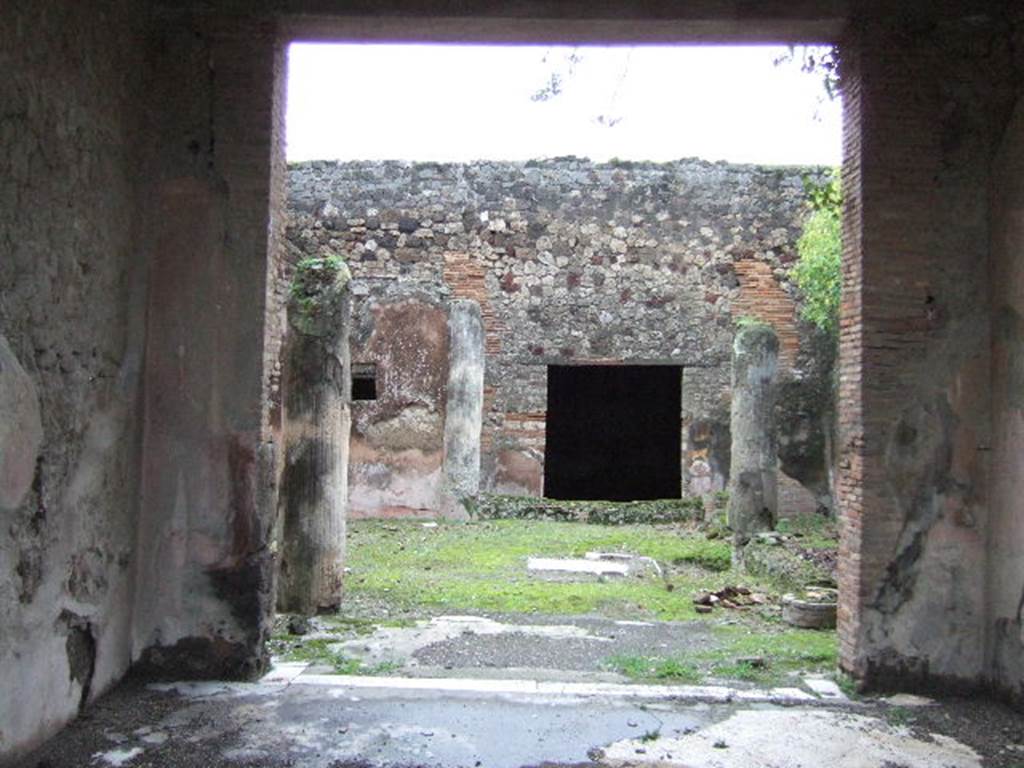 VII.10.3 Pompeii. December 2005. Looking east from tablinum into garden room 13.  According to Jashemski, the garden at the rear of the tablinum, excavated in 1863, was enclosed by a portico on the west, south and east sides. The portico was supported by five white, fluted, stuccoed columns.  There was an engaged column at the north-west corner.  A low wall joined the columns, leaving an entrance to the garden opposite the wide entrance from the tablinum.  At the south end of the garden was a small pool with a hole in the centre for a fountain jet.  There was a gutter around the edges of the garden.  On the north wall was a large animal painting, but nothing now remains of this painting except the wide red border.  There was a good view of the garden from the exedra at the rear.  
See Jashemski, W. F., 1993. The Gardens of Pompeii, Volume II: Appendices. New York: Caratzas. (p.191)