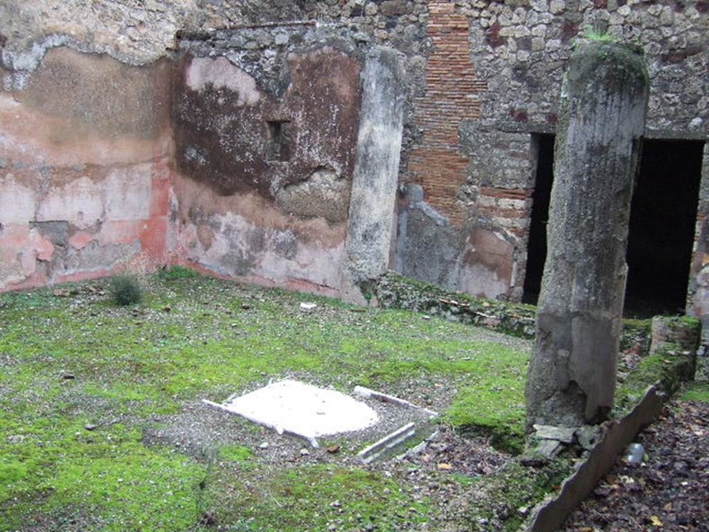 VII.10.3 Pompeii. December 2005. Looking towards east wall, and columns of portico joined a low wall, of garden room 13. (At the rear, the square doorway to the exedra can be seen in the photo above.)
According to Amoroso, at the rear of the atrium is a small internal courtyard or peristyle, reached by passing through the tablinum. Three rooms were on the east side of the peristyle, two of them opened onto it. He describes “our room 14” as a large exedra, and on its north side were two cubiculi (“our rooms 15 and 16”) in which was preserved a rich IVth style wall decoration.
Studi della Soprintendenza archeologica di Pompei, 22: l”Insula VII, 10 di Pompei, by Angelo Amoroso, (p.55) 
According to Breton, the low wall (pluteus) joining the columns was painted a very bright red. At the rear, east side, of the peristyle were two rooms. In the north wall of the exedra was a small back door that led into a very small room that seemed to have served as an anteroom for a well decorated room that had a second entrance onto the peristyle.
See Breton, Ernest. 1870. Pompeia, Guide de visite a Pompei, 3rd ed. Paris, Guerin.