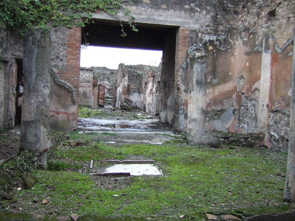 VII.10.3 Pompeii. December 2005.  Looking west from the exedra room 14, across the peristyle, through the tablinum, towards the house entrance. The doorway leading to VII.10.14 is on the left.