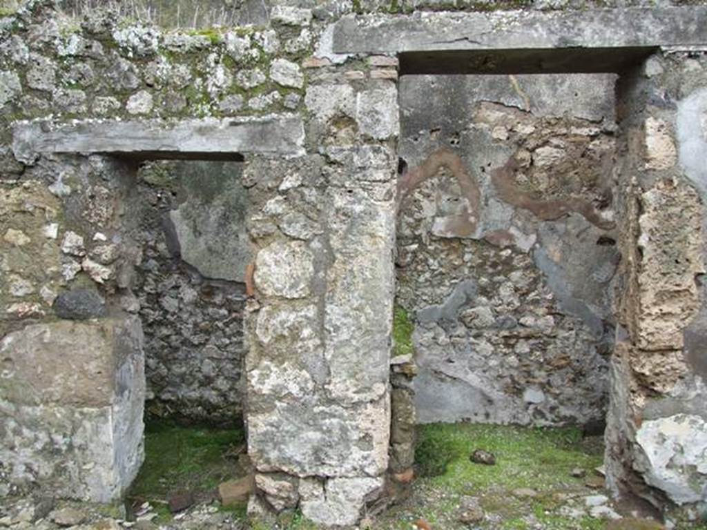 VII.10.9 Pompeii.  March 2009. The doorway on the left is to the Latrine, and the one on the right is to the Kitchen. Looking west from atrium of VII.10.12