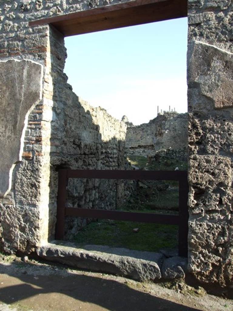 VII.11.2 Pompeii. December 2007. Entrance. According to Boyce, between the two entrances, on the pilaster on the left side above, Mercury was painted with an animal by his side. Helbig thought it resembled a dog more than a ram. Frohlich described it as vanished and destroyed.
See Boyce G. K., 1937. Corpus of the Lararia of Pompeii. Rome: MAAR 14. (p.111, no.20) 
See Helbig, W., 1868. Wandgemälde der vom Vesuv verschütteten Städte Campaniens. Leipzig: Breitkopf und Härtel. (12)
See Fröhlich, T., 1991. Lararien und Fassadenbilder in den Vesuvstädten. Mainz: von Zabern. (F56)