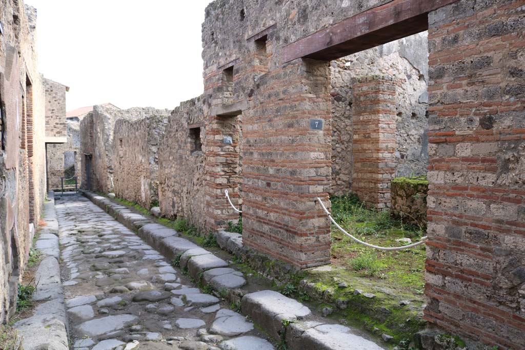 VII.11.7, Pompeii, on right. December 2018. 
Looking east from entrance doorway along Vicolo del Balcone Pensile, between VII.12, on left, and VII.11. Photo courtesy of Aude Durand.