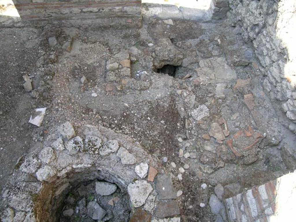 VII.11.7 Pompeii. June 2005. Looking north towards entrance doorway VII.11.7, on left, and VII.11.8, on the right. The cistern mouth has now been excavated from under the pile of stones/gravel, at the base of the masonry trough. Photo courtesy of Nicolas Monteix.