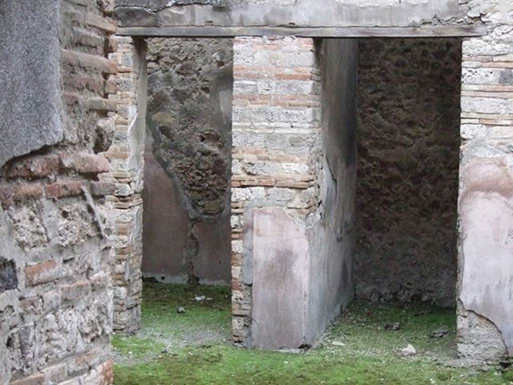 VII.11.11 Pompeii. December 2006. Doorways to rooms on south side of atrium.