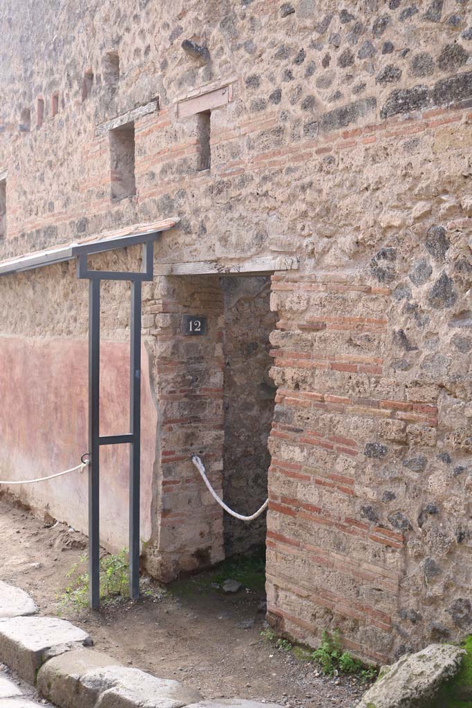 VII.11.12, Pompeii. December 2018. 
Entrance doorway, with phallus in wall above. Photo courtesy of Aude Durand.