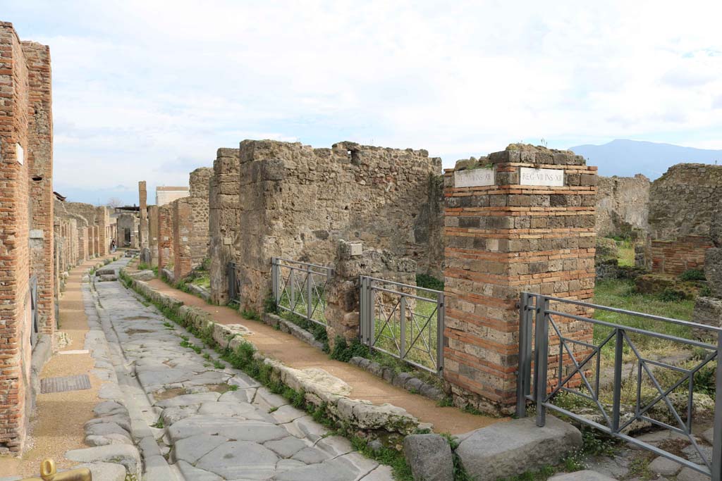 Via degli Augustali Pompeii, looking east. December 2018. 
The entrance doorway at VII.12.1 is right of centre. Photo courtesy of Aude Durand.
